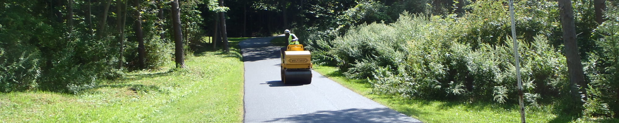 single worker on machine on the road