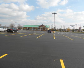 new parking lot pavement with sky overtop