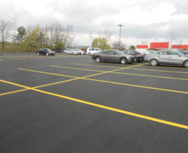 parking lot with plenty cars on top of pavement