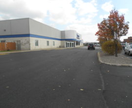 freshly paved parking lot in fall with trees