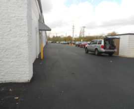 car with open trunk on fresh pavement