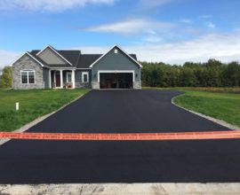 new house with new pavement parking lot