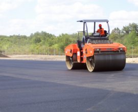 single worker paving the road