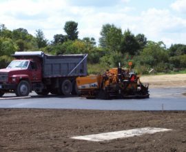 two machines on top of road
