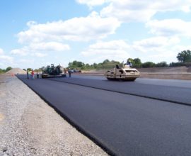 group of people working to smooth the ground