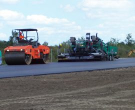 two machines side by side on pavement