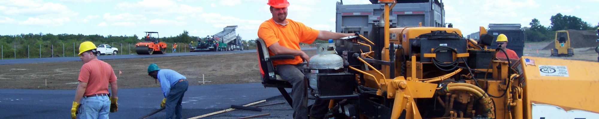 smiling construction worker outside paving
